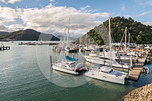 Yachts moored in Picton marina with Marlborough Sounds in background, New Zealand