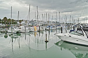 Yachts and motor boats docked in Half Moon Bay marina on a calm day