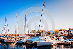 Yachts and pier at dusk. Luxury yachts docked in sea port at col