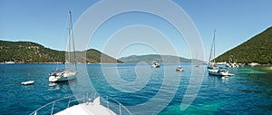 Yachts and sailboats anchored off the coast of Kefalonia island, Antisamos beach, Ionian sea, Greece