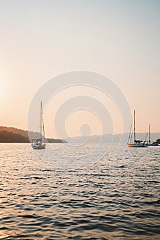 Yachts sailing in Aegean sea sunset view beautiful landscape travel yachting tour