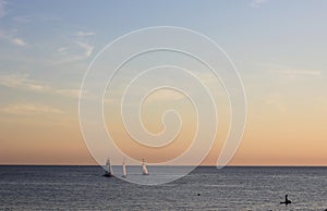 Yachts sailing in the black sea at sunset