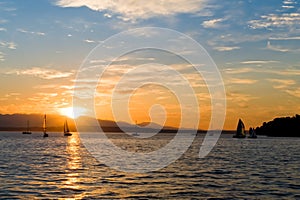 Yachts sailing at sunset