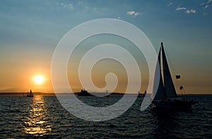 Yachts sailing at sunset