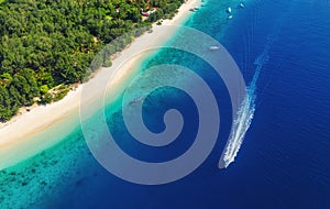 Yachts at the sea in Bali, Indonesia. Aerial view of luxury floating boat on transparent turquoise water at sunny day. Top view fr