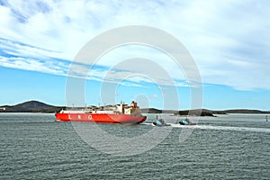 Yachts, seagoing vessels and tugboats on the roads of the port of Gladstone, Australia. December, 2019.