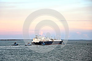 Yachts, seagoing vessels and tugboats on the roads of the port of Gladstone, Australia. December, 2019.