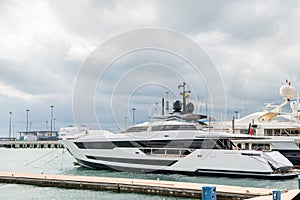 Speed boats at harbor. Power boats moored in marina. Sea coast pier