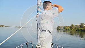 Yachtsman standing on bow of sailing yacht. Sport, recreation