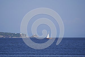 Yachtsmen travel on a wooden sailing yacht on the ocean Bay on a warm Sunny autumn day. A sailing ship goes on the sea