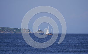 Yachtsmen travel on a wooden sailing yacht on the ocean Bay on a warm Sunny autumn day. A sailing ship goes on the sea