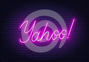 Yahoo neon sign on brick wall background.