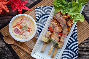 Yakitori and Chawan Mushi- Japanese grilled chicken skewer and steamed egg at top view on wood table