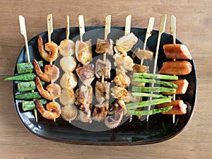 Yakitori: Japanese bite-sized food skewers: asparagus, sausage, scallop, squid, mushroom, prawns, chicken, pork, beef and okra