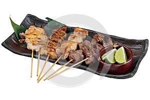 Yakitori Japanese-Style Grilled Chicken Skewers with chicken and internal organ served with sliced lime.