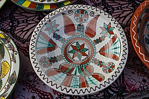 Yakushyntsi, Ukraine, traditional ceramic clay plate on sale, Podillia style flower and geometrical ornament painting