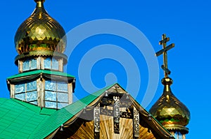 Yakut patterns under the roof of the Orthodox Church with Golden domes and crosses made of wood. photo