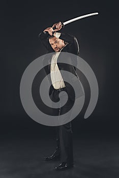 yakuza member in suit with katana sword