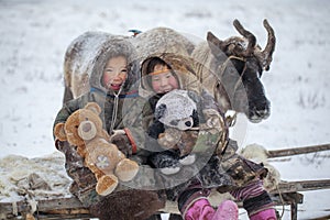 The Yamal Peninsula, the extreme north. Happy boy and girl on reindeer herder pasture in a cold winter day, polar circle, children