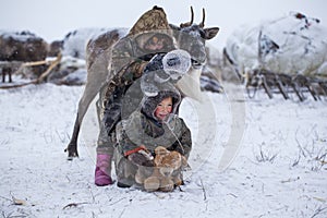 The Yamal Peninsula  the extreme north. Happy boy and girl on reindeer herder pasture in a cold winter day  polar circle  children