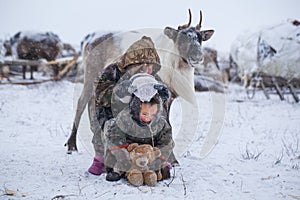 The Yamal Peninsula  the extreme north. Happy boy and girl on reindeer herder pasture in a cold winter day  polar circle  children