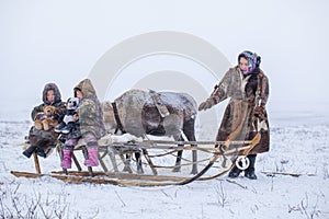 The Yamal Peninsula  the extreme north. Happy boy and girl on reindeer herder pasture in a cold winter day  polar circle  children