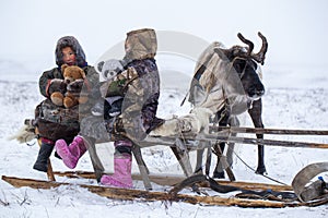 The Yamal Peninsula  the extreme north. Happy boy and girl on reindeer herder pasture in a cold winter day  polar circle  children