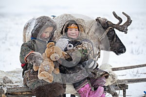 The Yamal Peninsula  the extreme north. Happy boy and girl on reindeer herder pasture in a cold winter day  polar circle  children