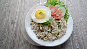 Yang Chow fried rice with slice tomato and cucumber on a white plate