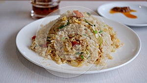 Yang Chow fried rice on a white plate with chilli oil.