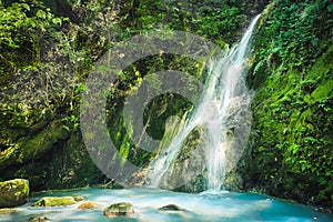 Xiao Yintang Waterfall of Yangmingshan National Park with milky cold spring and sunlight on sunny day, shot in Taipei, Taiwan.