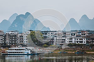 YANGSHUO, CHINA - MAY 26, 2018: Scenic landscape at Yangshuo County of Guilin. Li River (Lijiang River). Pleasure boats at the pi