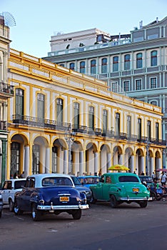 Classic vintage old Cuban yank tank tanks car in Havana Cuba with Yellow Building background