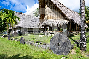 Yapese thatched old traditional meeting houses with money bank in front, Yap Island, Micronesia