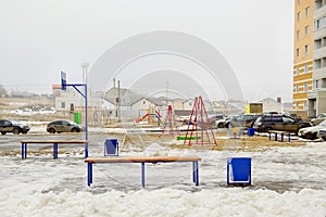 Yard, bench, playground - courtyard in a residential area of Russia, winter