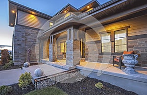 Yard and pathway in front of the porch of a home with stone brick wall