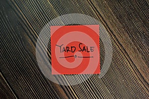 Yard Sale write on sticky notes isolated on Wooden Table