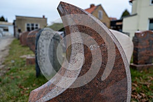 in a yard of a stonemason's workshop there are many different gravestones next to each other