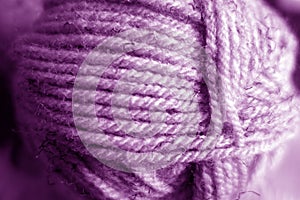 Yarn ball close-up with blur effect in purple tone