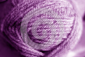 Yarn ball close-up with blur effect in purple tone