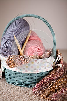 Yarn balls and round needles set in a basket