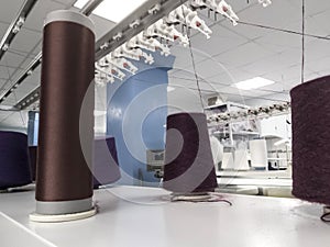 yarn in bobbins on knitting machines during operation