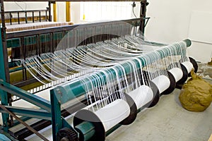 Yarn bobbins on loom framework