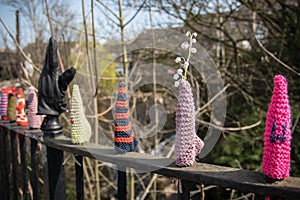 Yarn bombing of railing fene with knitted and crochet items