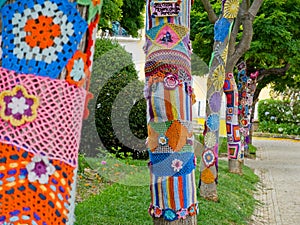 Yarn bombing in trees. European park.