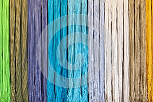 Yarn dyed thread or cord or packthread color hang on the wall for background usage.