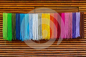 Yarn dyed thread or cord or packthread color hang on the wall for background usage.