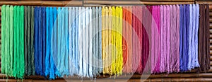 Yarn dyed thread or cord or packthread color hang on the wall for background usage.