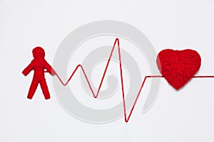 Yarn heart and human figure with thread like ECG pattern