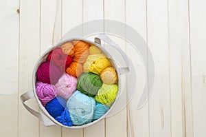 Yarn for knitting rainbow. Wood background